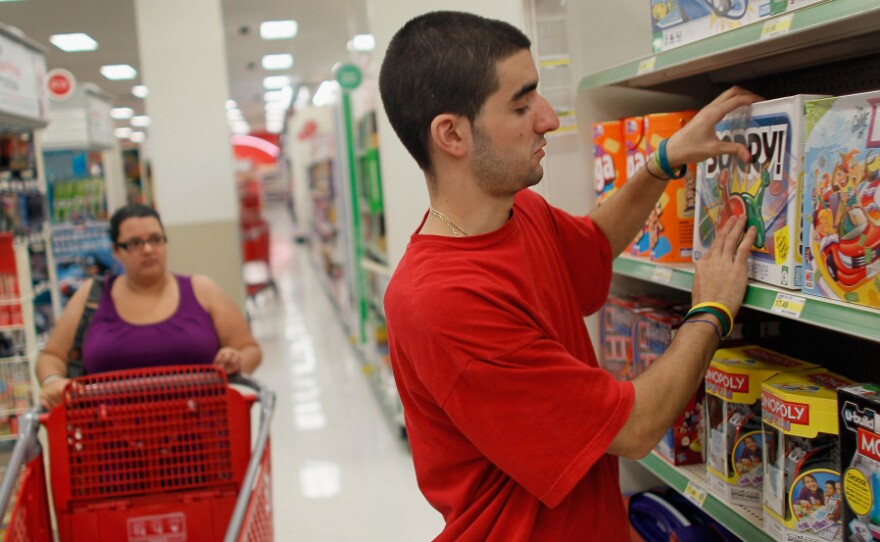 Christian Hernandez stocks shelves earlier this month at a Target store in Miami. Target reported strong profit numbers in the second quarter of 2011 in its continued battle with Walmart stores over discount retail dominance.