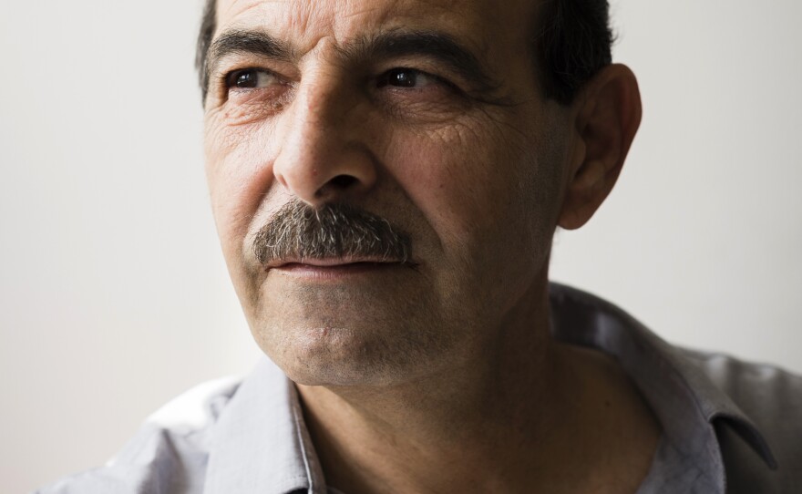 Syrian lawyer and human rights advocate Anwar al-Bunni has been living in Germany since 2014. Working with witnesses and other rights lawyers, he has been collecting evidence about Syrian war crimes. Above, he sits in his Berlin office.