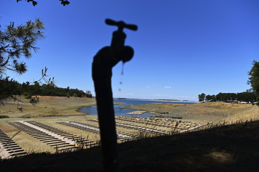 Water drips from a faucet near boat docks sitting on dry land at the Browns Ravine Cove area of drought-stricken Folsom Lake, in Folsom, Calif., on May 22, 2021.