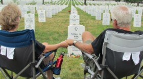 Vikki and Mark Pier visit the grave of their son, Noah, who was buried at Arlington National Cemetery in July 2011. They used to visit every few months, but they have been unable to make it in recent years.