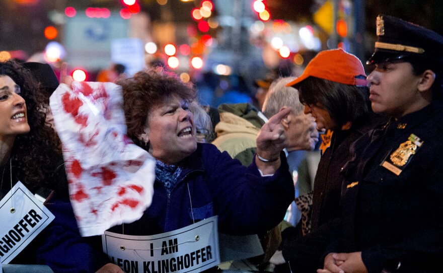 Protesters engage people thought to be ticket holders near Lincoln Center as they protest the opera "Death of Klinghoffer" on Monday in New York.