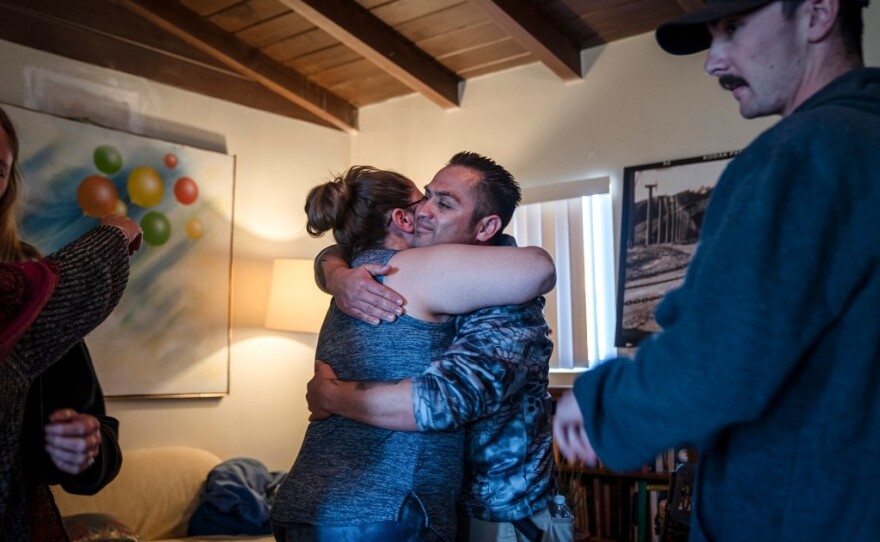 Cal Fire dispatcher Ali Wiseman and Captain Hiram Vazquez embrace during a healing session at a trauma retreat in Desert Hot Springs.
