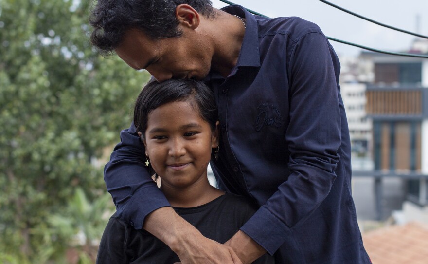 Sayyid Ali Hussaini kisses his 9-year-old daughter Elisa. "Those things I witnessed in my childhood, I don't want them for my girl," he says. "For this I'm here. To have a peaceful life, to continue life in a peaceful way."