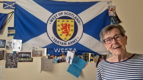 Moira Brown, 93, at her home in Glasgow, where the walls are plastered with Scotland soccer memorabilia.