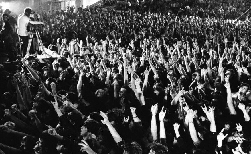 Fans pack a concert by the band Alisa, a favorite of the Leningrad Rock Club. This 1988 show was held in a larger venue amid the emerging freedoms of the perestroika era.