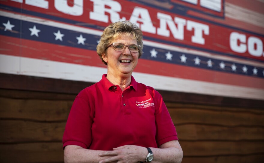 Elizabeth Kopecky, a manager at Hickory Park, stands outside the restaurant. She says hiring is tricky, often with little time to check references.