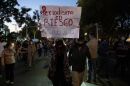 Journalists and supporters hold signs as they protest the murders of their colleagues Lourdes Maldonado and Margarito Martinez in Tijuana, Baja California, Mexico. The sign says, "Journalism at risk. Don't kill the truth." Jan. 25, 2022.