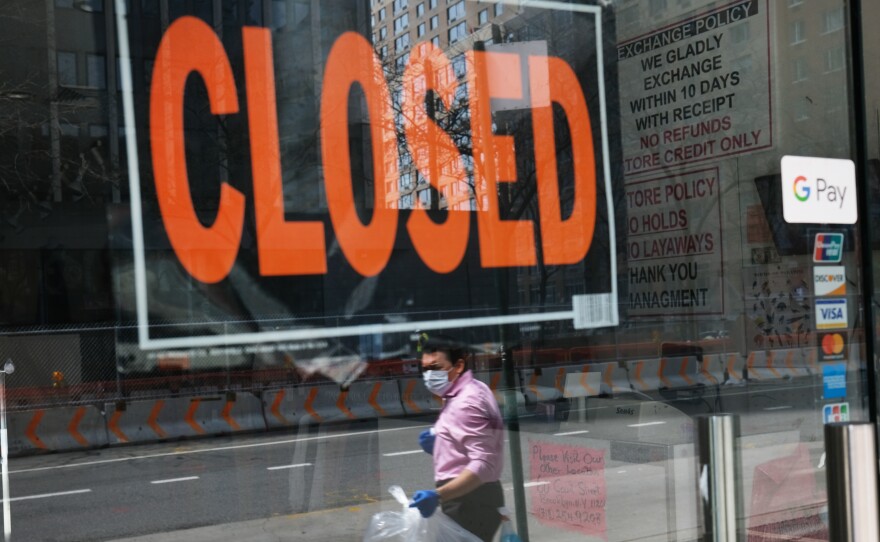 A closed sign is displayed in the window of a business in a nearly deserted lower Manhattan on April 17, 2020, in New York. Many small businesses benefitted from a government emergency loan program during the pandemic, but its effectiveness is still in doubt.