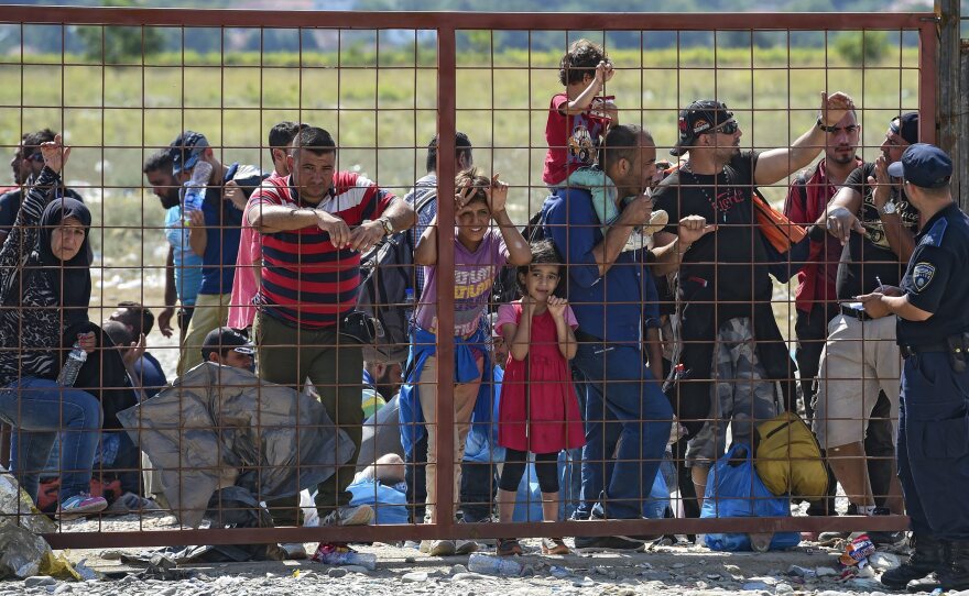 A group of migrants wait for permission to enter a registration camp near the town of Gevgelija, Macedonia, on Monday.