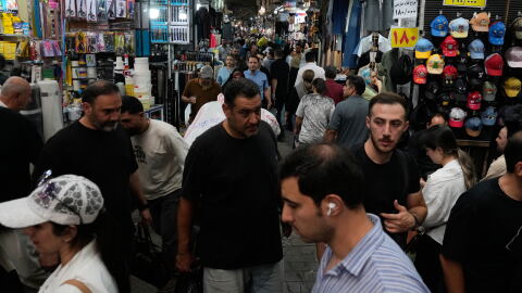 People walk in Tehran's traditional main bazaar, Iran, Saturday, Aug. 8, 2026.