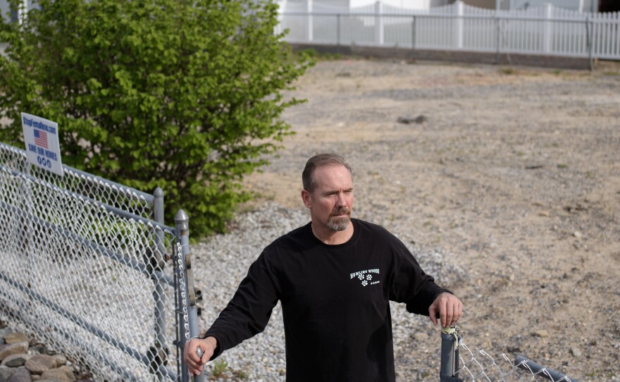 Doug Quinn stands on the empty lot where his house used to be.