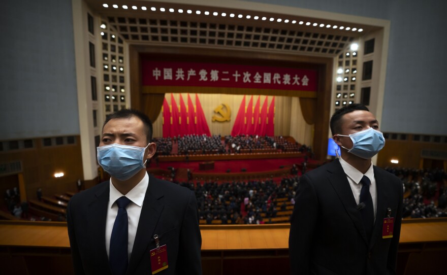 Security officers wearing face masks stand guard after the opening ceremony of the 20th National Congress of China's ruling Communist Party at the Great Hall of the People in Beijing.