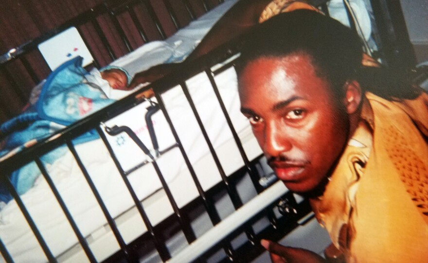In this undated family photo, James Carter poses with his newborn son.