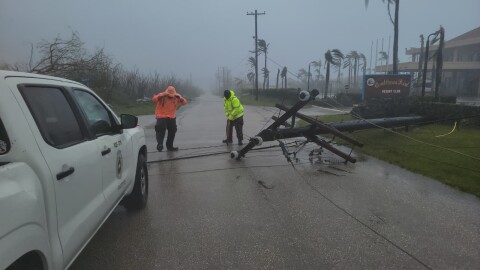 A utility pole blocks the road in Saipan on Wednesday as a super typhoon with ferocious winds and relentless rains, shredded tin roofs and forced residents to take cover from flying tree limbs.