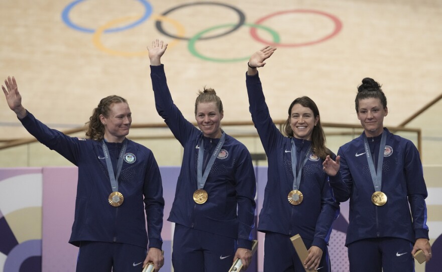From left, United States' Lily Williams, Jennifer Valente, Kristen Faulkner and Chloe Dygert pose with the gold medal of the women's team pursuit event, at the Summer Olympics, Wednesday, Aug. 7, 2024, in Paris, France.