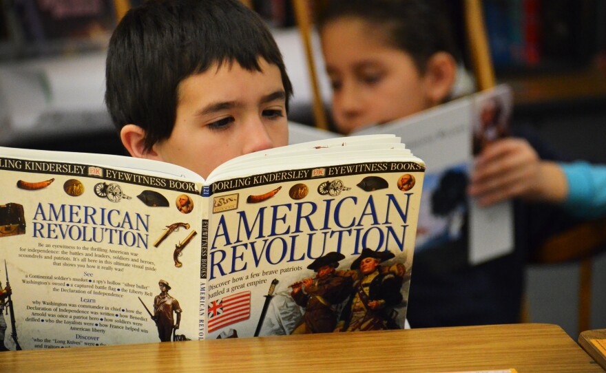 Fourth-grader Isiah Soto digesting some history during independent reading time.
