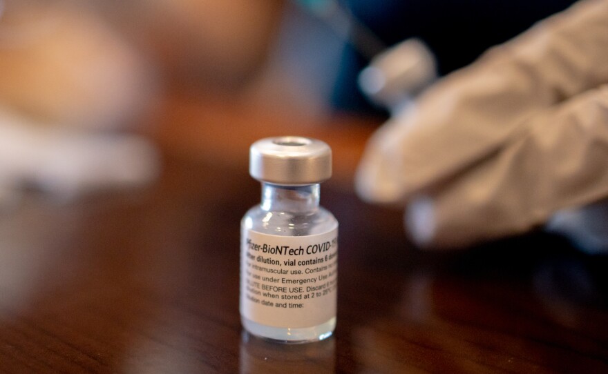 A health care worker prepares Pfizer-BioNTech Covid-19 vaccines for third doses at a senior living facility in Worcester, Penn., in late August.