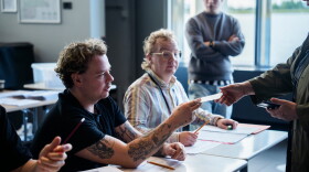 An election worker assists a voter at a polling station inside Reykjavik City Hall in Reykjavik, Iceland, Saturday, Aug. 29, 2026.