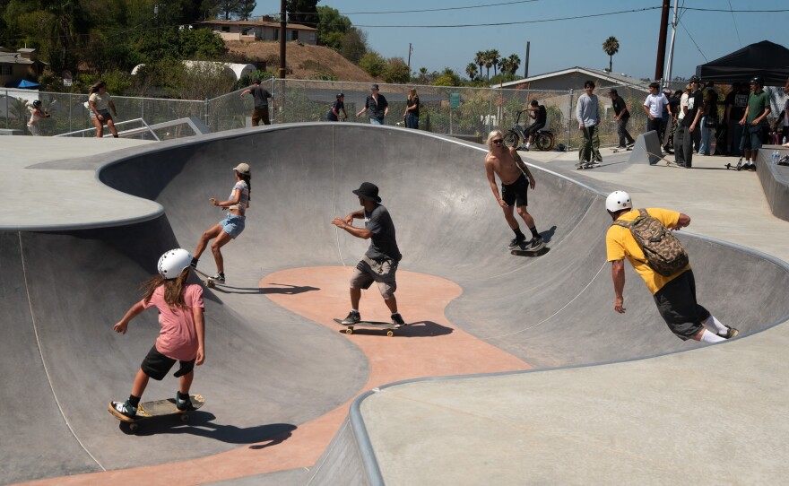 Skateboarders riding on the snake bowl at the skatepark at the newly open Village View County Park, Sept. 4, 2025.