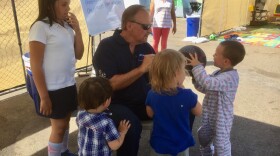 Bob McElroy, CEO of the Alpha Project, talks to children at the homeless transitional camp near downtown San Diego, Oct. 17, 2017.