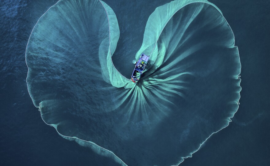 The fishermen in Phu Yen, Vietnam, cast their nets every day. From above, the photographer observes, this net looks like a heart of the sea.