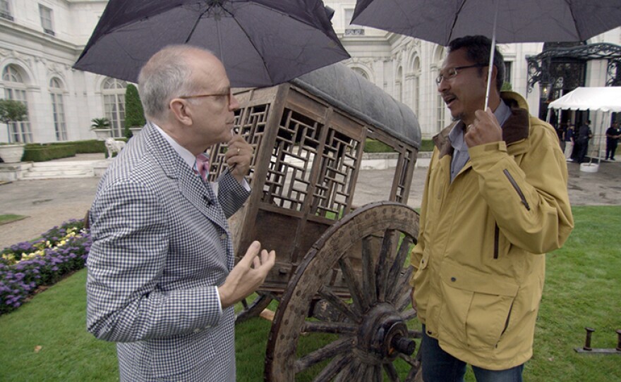 Lark Mason (left) appraises a 19th C. Chinese carriage in Newport, R.I.