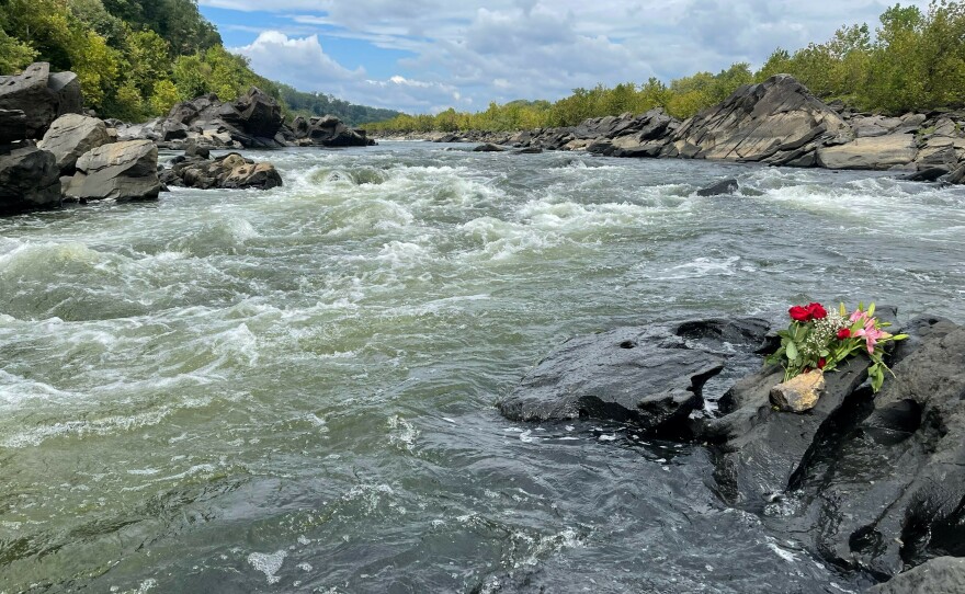 Washington-area whitewater kayakers lay flowers on the Potomac's Little Falls rapid near the rocks that entrapped visiting kayaker Ella Mills.