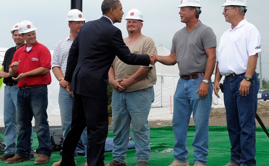 President Obama greets workers as he prepares to give a speech at the groundbreaking for a battery plant in Holland, Mich., on July 15.
