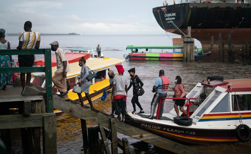Commuters land at a port near Stabroek Market in Georgetown. The seawall that stretches along Guyana's coast can be traced back to Dutch colonizers, who reclaimed the low-lying, marshy plains to expand their land.