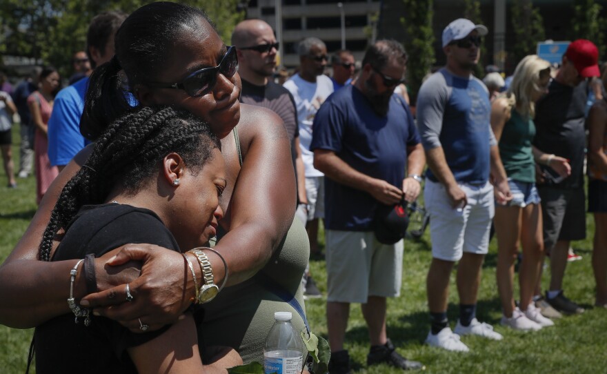 Mourners gather at a vigil following a nearby mass shooting on Sunday in Dayton, Ohio.