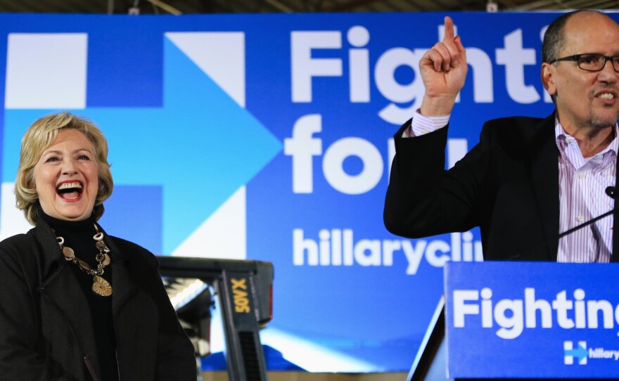 Democratic presidential candidate Hillary Clinton laughs as Labor Secretary Tom Perez endorses her during a campaign stop in Sioux City, Iowa, in December 2015.