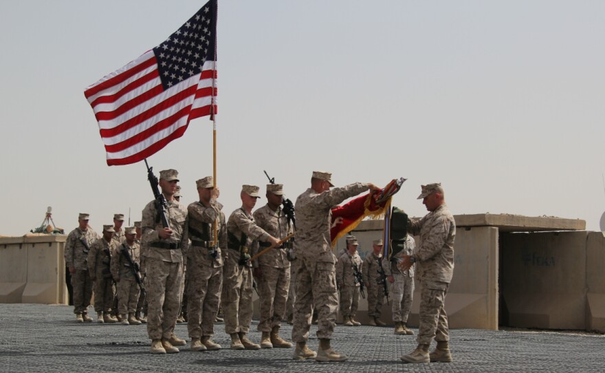 Regimental Combat Team 7 cases its flag during their mission's closing ceremony in Helmand Province, Afghanistan.
