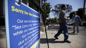 A closure sign covers the entrance to an empty stadium where SeaWorld normally hosts its "Sea Lions Live" show, March 10, 2015. 