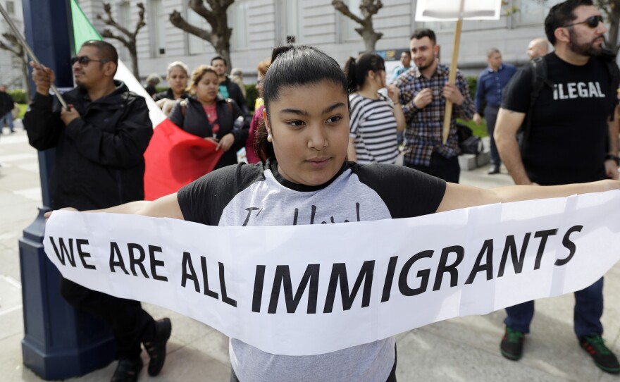 Delilah Gutierrez holds a sign during a protest against President Trump's efforts to crack down on immigration in San Francisco earlier this year.