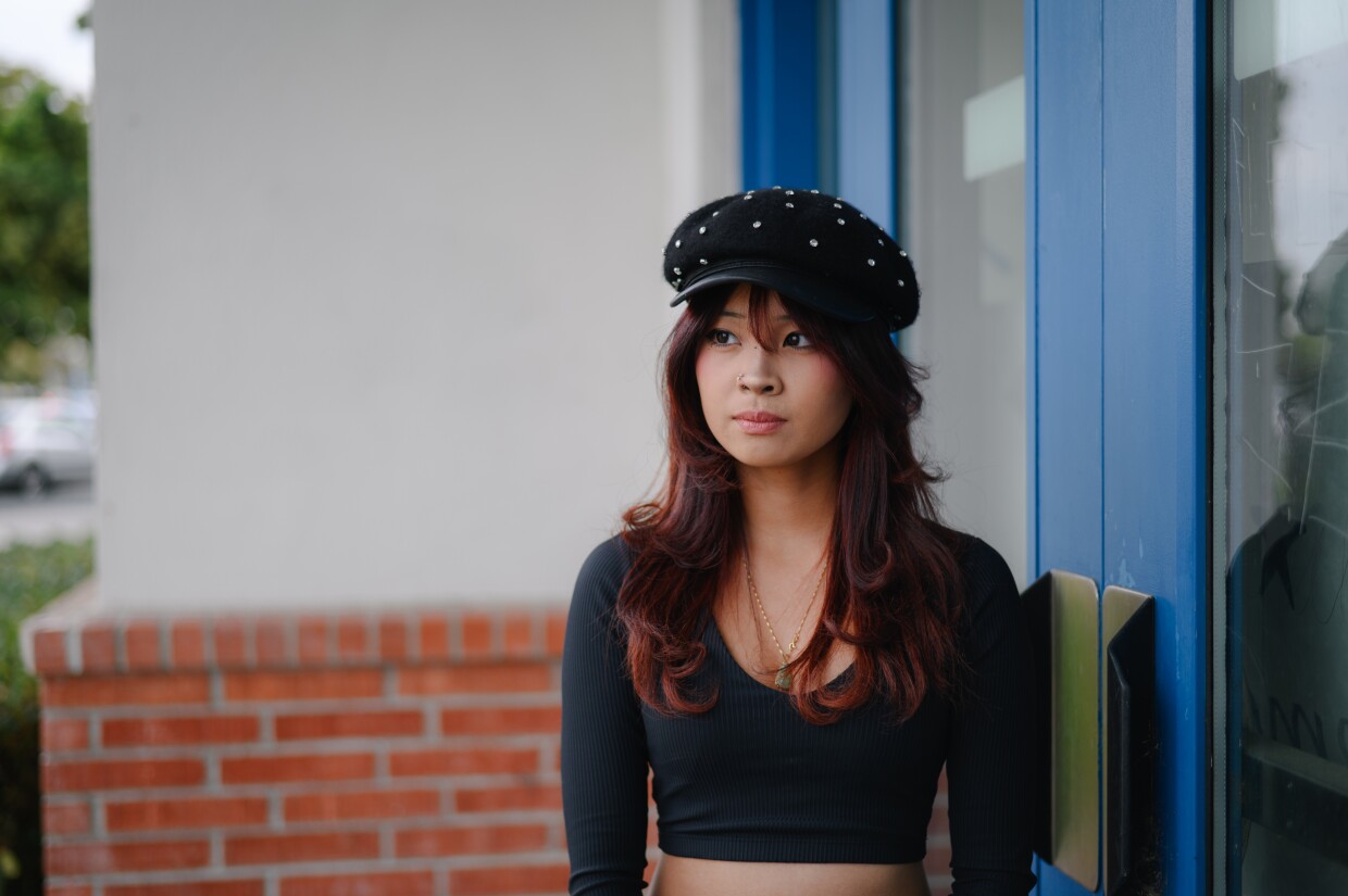 Chula Vista High orchestra student Vivi Gonzales stands for a portrait outside the high school in Chula Vista, California on Dec. 11, 2024. The school district is proposing schedule cuts that many Chula Vista High students worry will hurt the school’s renowned arts program.