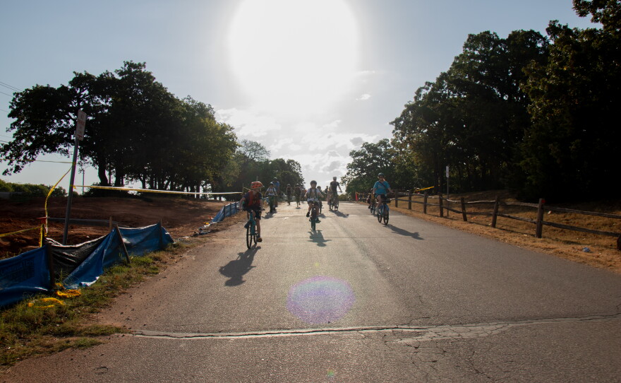 Will Rogers Elementary students cruise down a hill on their route to school after a routine brake check. Parents, students and a car monitor ride about a mile from the park to the school as part of what's called a bike bus.