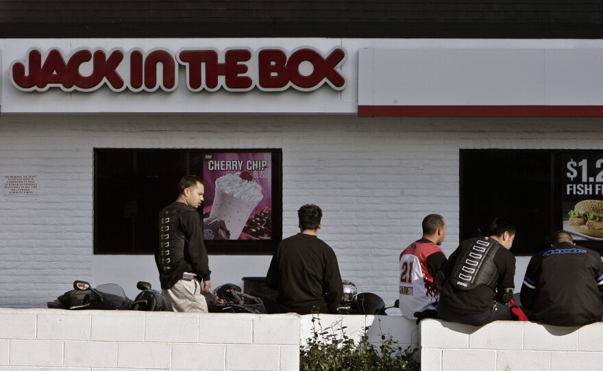 In this Feb. 17, 2008 file photo, Jack in the Box customers gather in its parking lot in Los Angeles.
