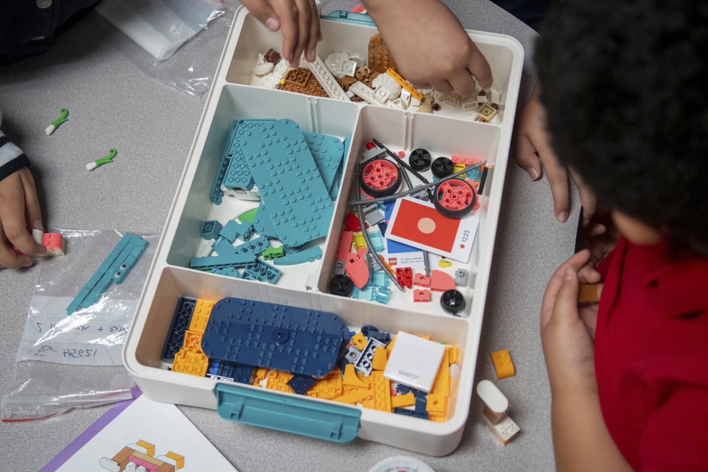 Students look through a box of LEGO bricks during class at Lively Elementary on Thursday, Aug. 21, 2025, in Irving, Texas.