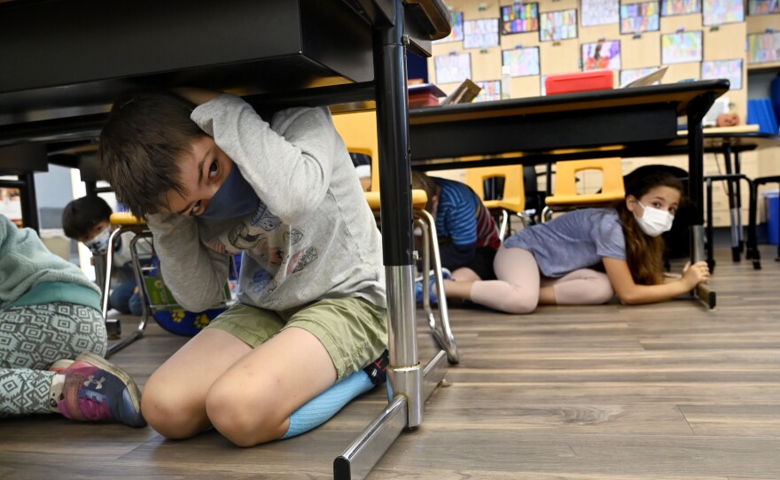 Third grade students in Mrs. Jordan's class participate in the Great Shakeout annual earthquake drill at Pacific Elementary School in Manhattan Beach on Thursday, October 21, 2021.