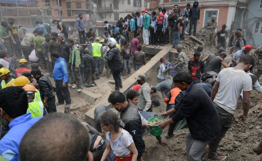 People clear rubble in Kathmandu's Durbar Square, a UNESCO World Heritage Site that was severely damaged by the earthquake.