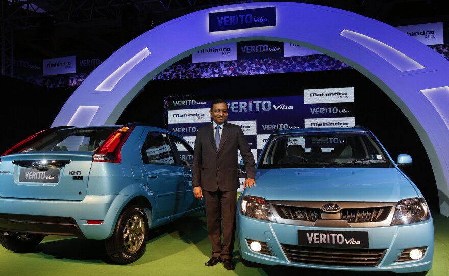 Pawan Goenka of the Indian manufacturing company, Mahindra, poses with the Verito Vibe compact car in Mumbai in 2013.