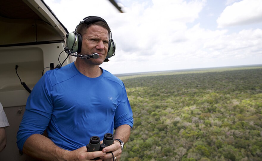 Steve Backshall looking out into the distance from helicopter.