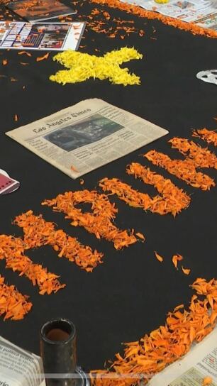 Marigold petals frame newspapers, a visual to honor journalists who have passed for Día de Muertos in Tijuana on Oct. 31, 2025