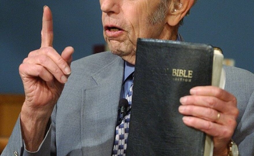 Harold Camping speaks, holding a Bible, during his live television broadcast in 2002.
