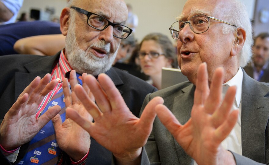 British physicist Peter Higgs (right), who proposed the Higgs boson in the 1960s, speaks with Belgium physicist Francois Englert at Wednesday's event.