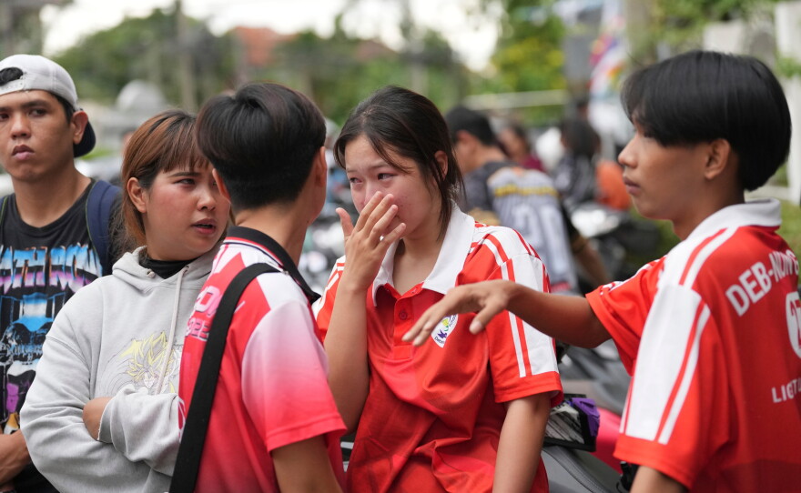A schoolgirl cries outside her school where deaths and injuries were reported after a shooting in Thailand's Nonthaburi province, Friday, Aug. 7, 2026.