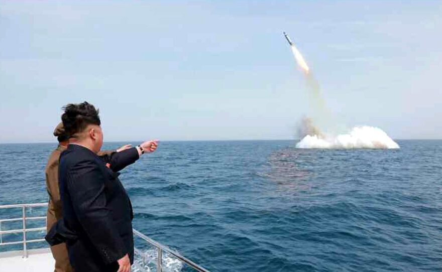 An image obtained by Yonhap News Agency showing North Korean leader Kim Jong Un pointing at a ballistic missile believed to have been launched from underwater near Sinpo, on the northeast coast of North Korean, on Saturday.
