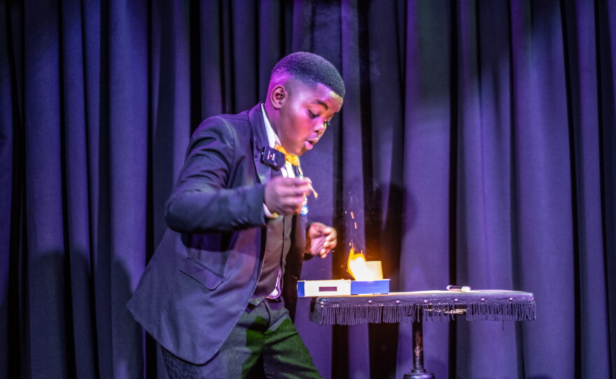 Lubelo Mthenjana, who's 11, performs a magic trick involving fire during the annual junior magic contest at the College of Magic in Cape Town, South Africa.