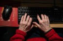 An elderly person types on a keyboard in this undated photo.