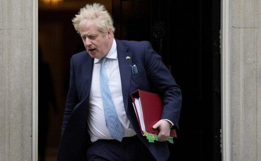 Prime Minister Boris Johnson leaves 10 Downing Street to attend the weekly Prime Ministers' Questions session in parliament in London, on March 30. Johnson's office says he will be issued a fine for breaching COVID-19 regulations following allegations of lockdown parties at government offices.